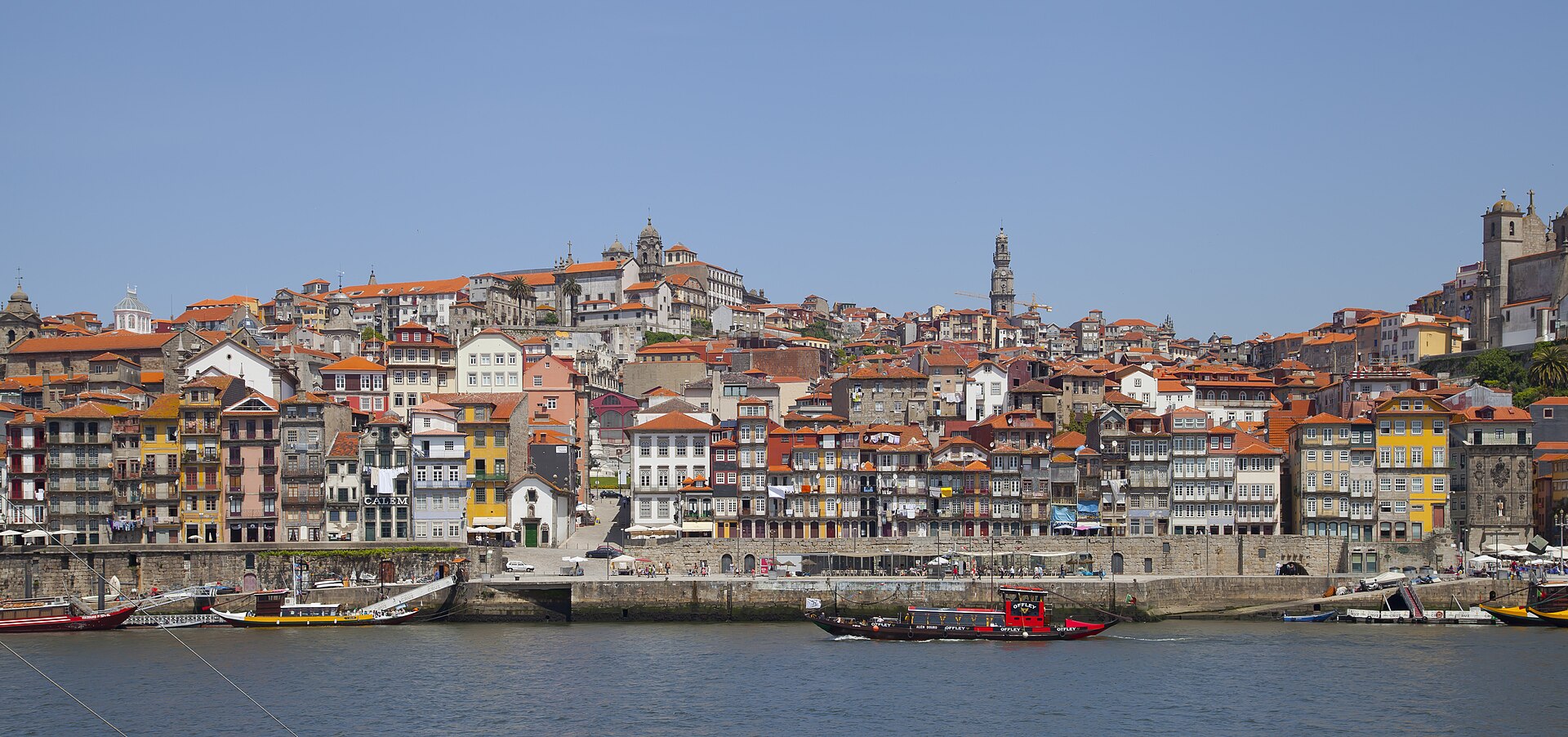 Colorful Ribeira waterfront buildings and boats on the Douro River in Porto